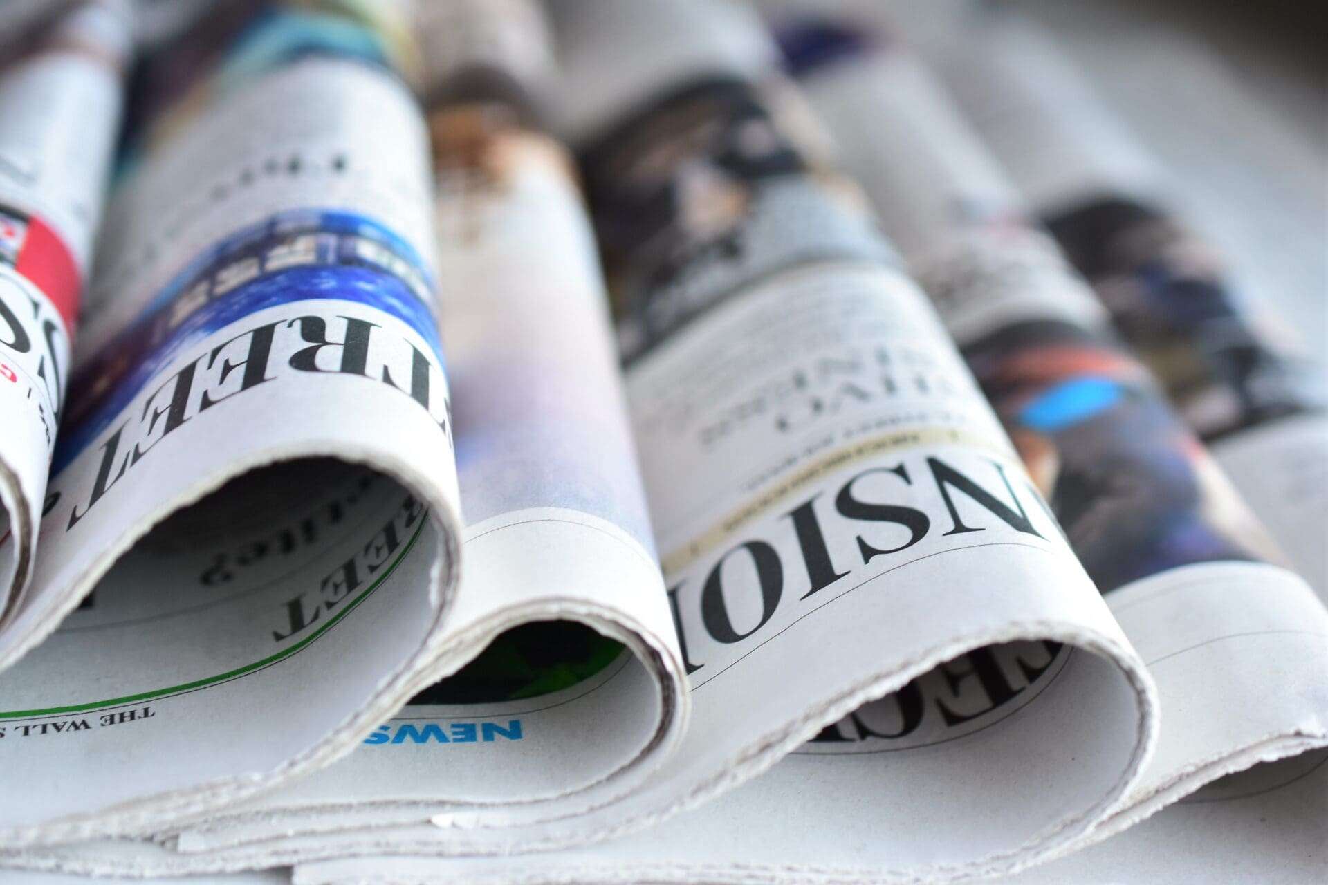 Set of newspapers folded next to each other